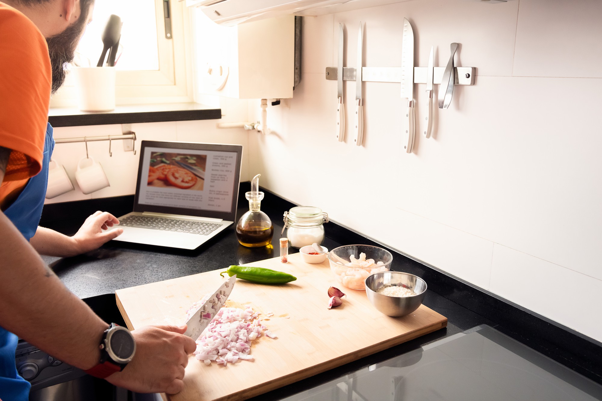 Workspace with cooking tools and laptop for online class